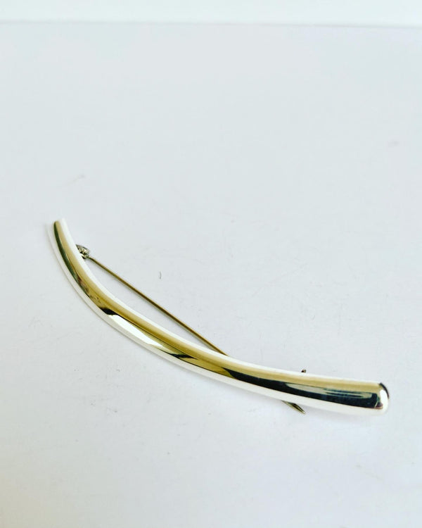 Sleek silver sculptured brooch